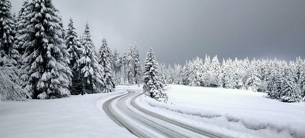 Road passing through snow covered landscape