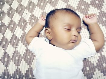 Baby girl sleeping on bed