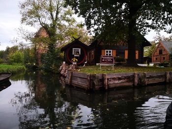 House by lake against building