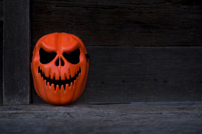 View of pumpkin on wooden wall during halloween