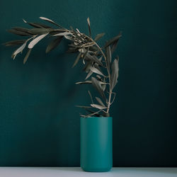 Close-up of potted plant on table against wall