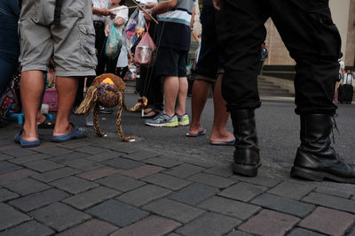 Low section of people standing on zebra crossing