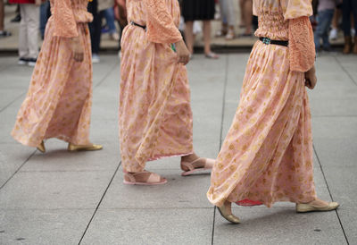 Low section of woman walking on street