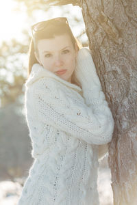 Portrait of woman with snow on tree