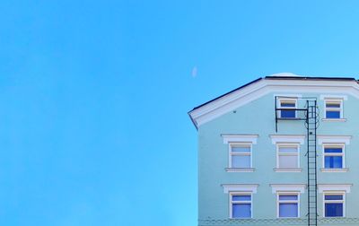 Low angle view of building against clear blue sky