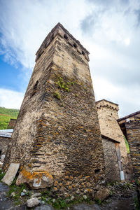 Low angle view of old building against cloudy sky