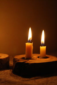 Close-up of lit candle in the dark