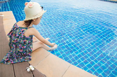 High angle view of woman sitting in swimming pool