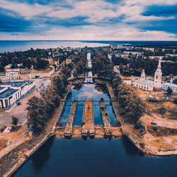 High angle aerial view of old locks and water channel against cloudy sky