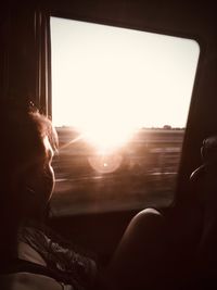 Woman looking through window