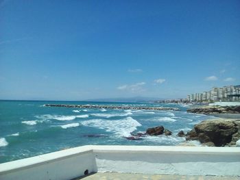 Scenic view of sea against clear blue sky