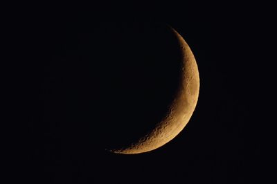 Low angle view of half moon against sky at night