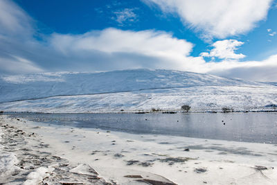 Scenic view of sea against sky during winter