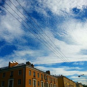 Low angle view of building against cloudy sky