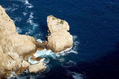 High angle view of rock formation in sea