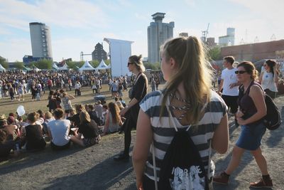 Rear view of young woman looking at city
