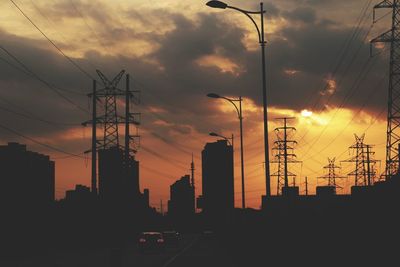 Silhouette city against sky during sunset