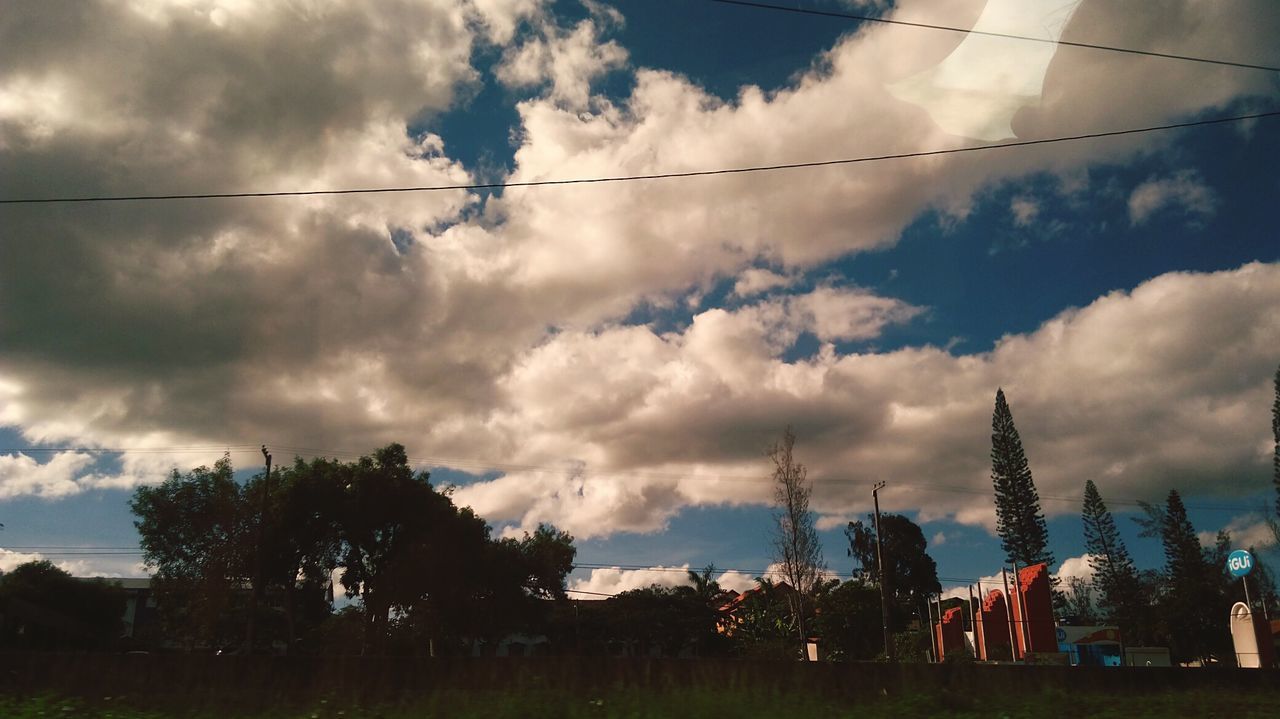 sky, cloud - sky, tree, built structure, architecture, cable, nature, building exterior, outdoors, no people, tranquility, beauty in nature, day, low angle view, electricity pylon, scenics, landscape, telephone line