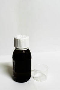 Close-up of wineglass on table against white background