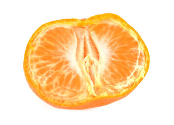 Close-up of orange slice against white background