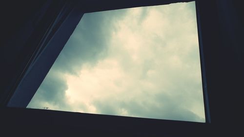 Low angle view of building against cloudy sky