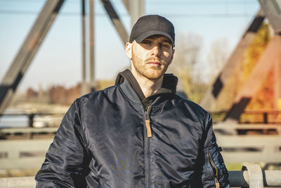 Portrait of young man standing outdoors