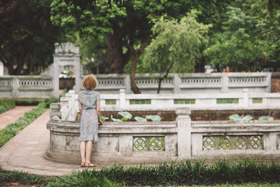 Rear view of woman standing in park