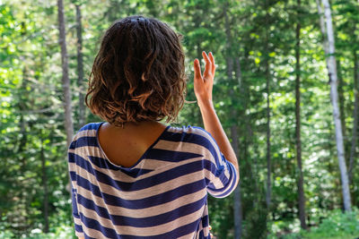 Rear view of senior woman in forest