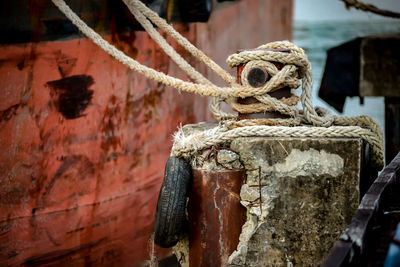 Close-up of rope tied on rusty metal