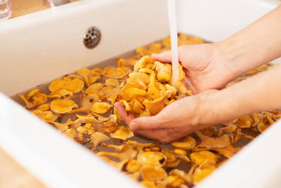 Forest mushrooms are washed in the sink