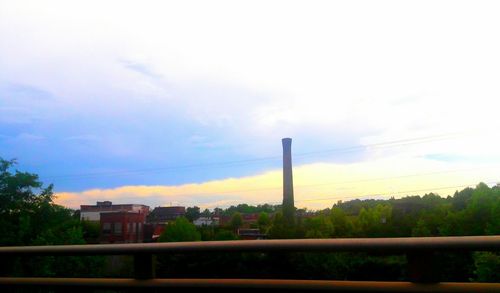 Factory against sky during sunset