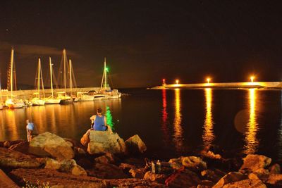 View of boats in sea at night