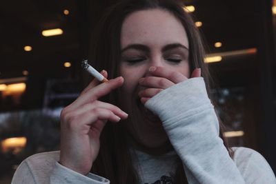 Young woman holding cigarette