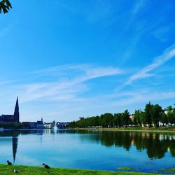 Scenic view of river against blue sky