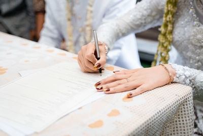 Midsection of man working at table