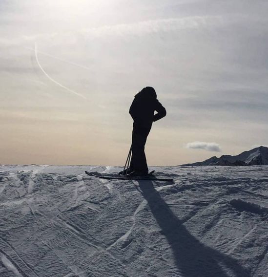 winter, one person, snow, sky, nature, cold temperature, silhouette, cloud, environment, landscape, leisure activity, adult, beauty in nature, skiing, ice, full length, scenics - nature, day, mountain, lifestyles, sunlight, standing, sea, land, ocean, outdoors, wave, snowboarding, side view, vacation, frozen, tranquility, holiday, trip, water, women, back lit, sand