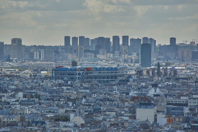 High angle view of buildings in city against sky