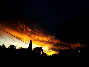 Silhouette trees against sky during sunset