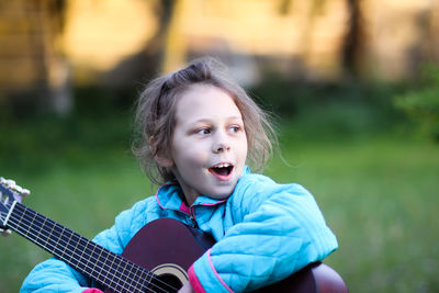 Portrait of a girl playing guitar