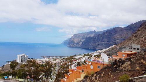 Panoramic view of town against cloudy sky