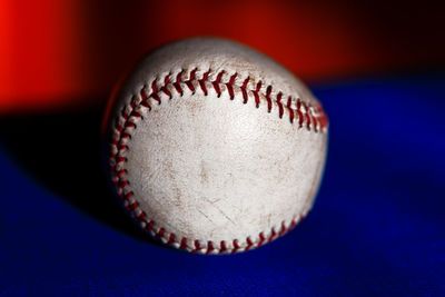 Baseball ball . blue and red background . sports leather ball sewn with thread