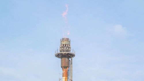 Low angle view of communications tower against sky