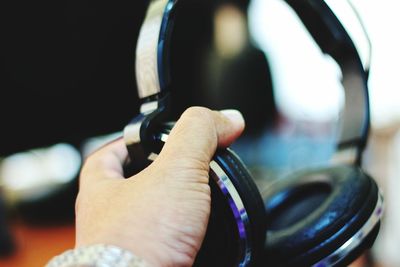 Close-up of hand holding headphones