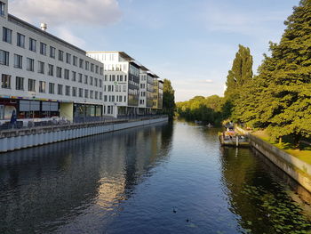 River amidst buildings against sky