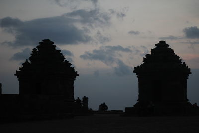 Low angle view of silhouette temple against sky at sunset