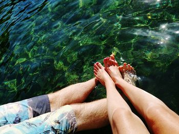 Low section of people relaxing in sea