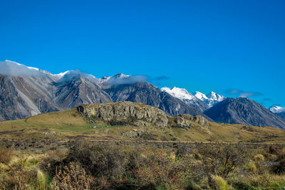 Scenic view of snowcapped mountains against clear blue sky