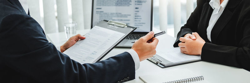 Midsection of businessman working at desk in office