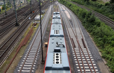 Multiple railroad tracks with junctions at a railway station in a perspective view