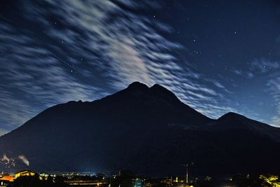 Scenic view of mountains against sky at night